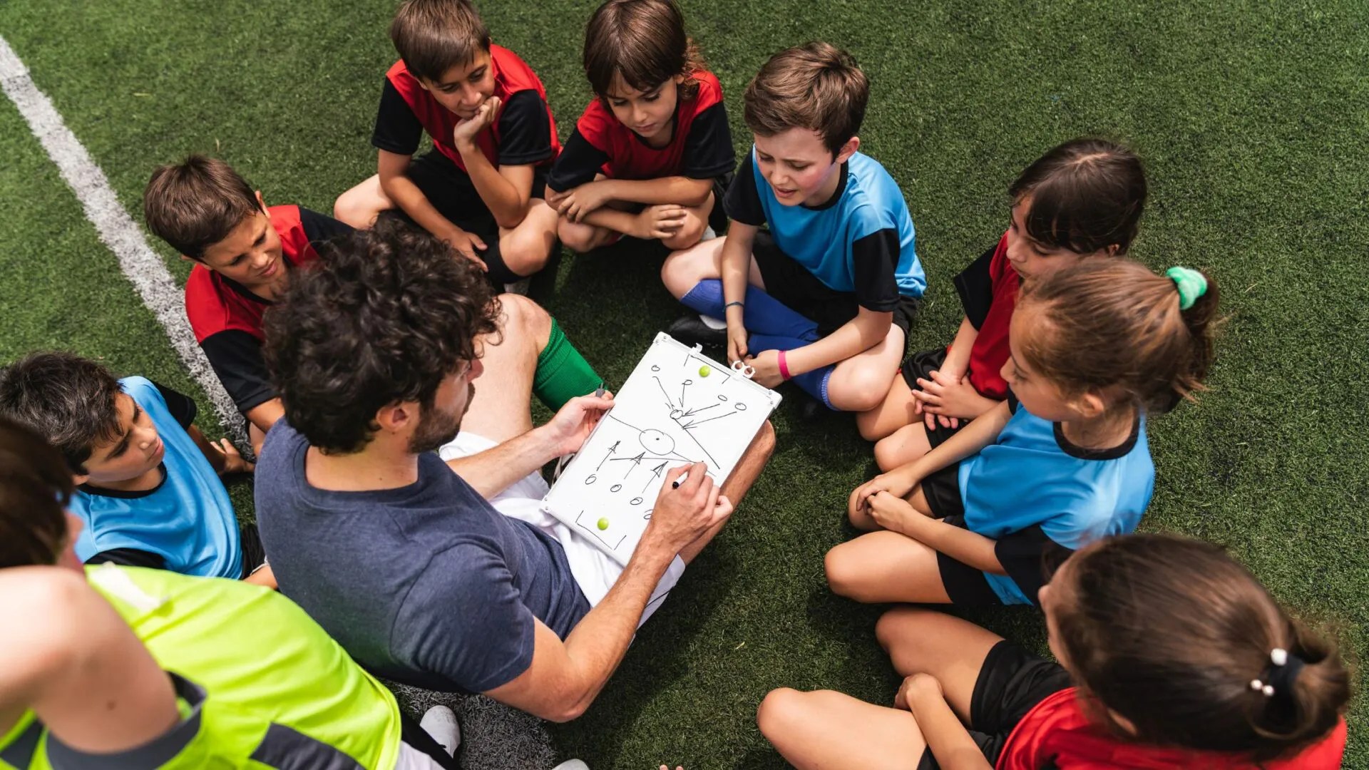 constraints-led coaching session with a coach observing from a distance