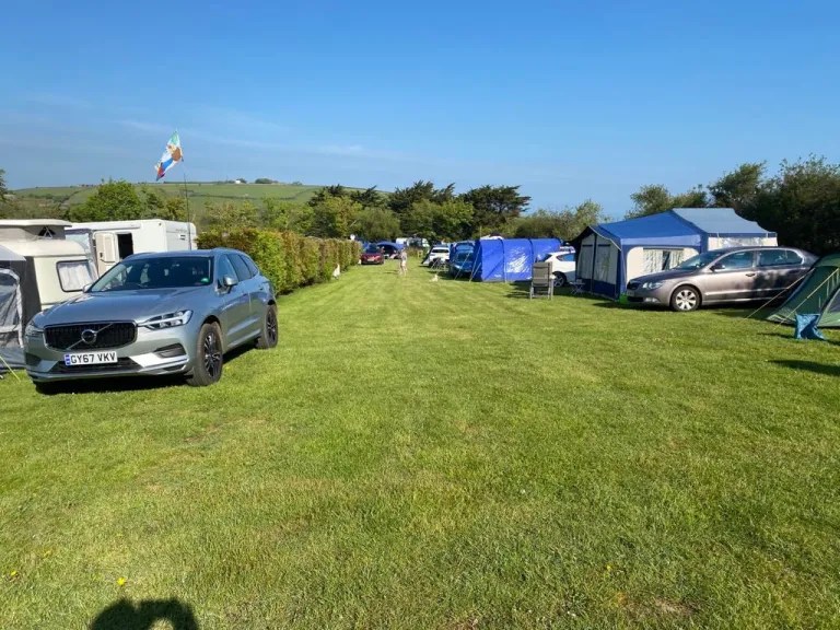 Lynmouth Holiday Retreat: Campsite with tents, cars, and caravans.