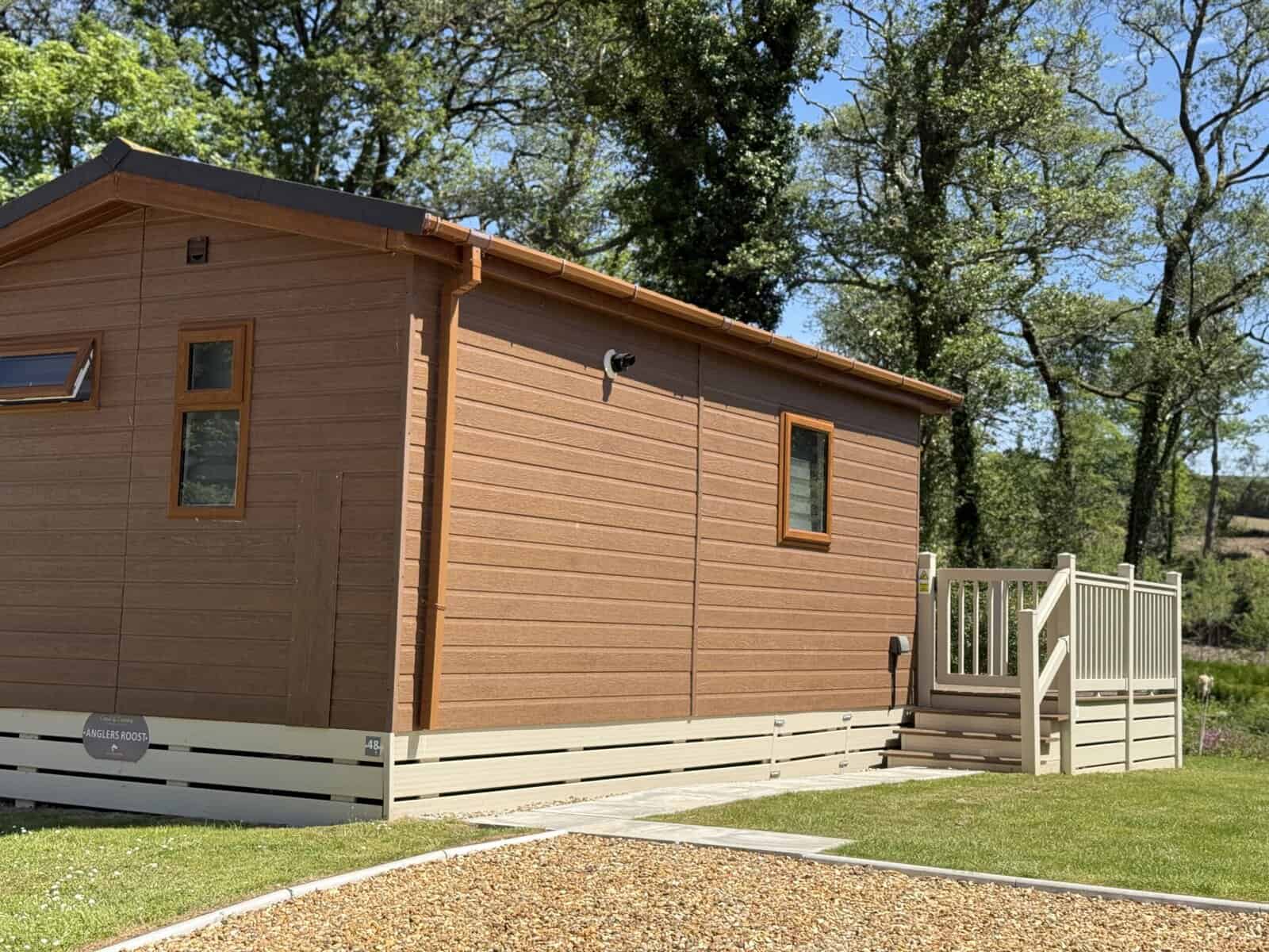 Anglers Roost lodge, number 48, with wooden deck and steps.