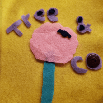 Tree & co album cover crafted in felt. There is a geometric tree with a teal trunk and pink leaves