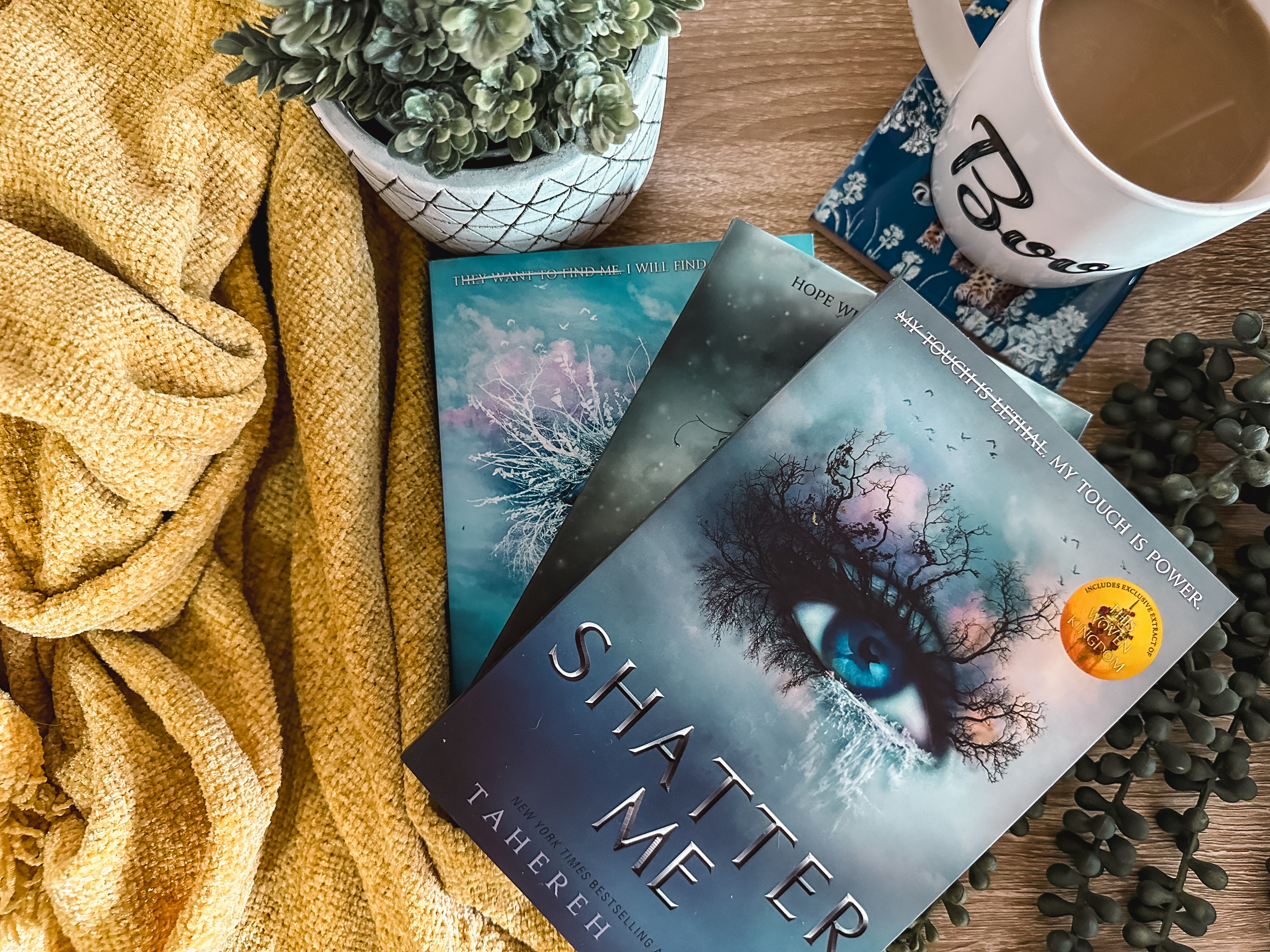 A flatlay of the Shatter Me books for the Shatter Me series review.