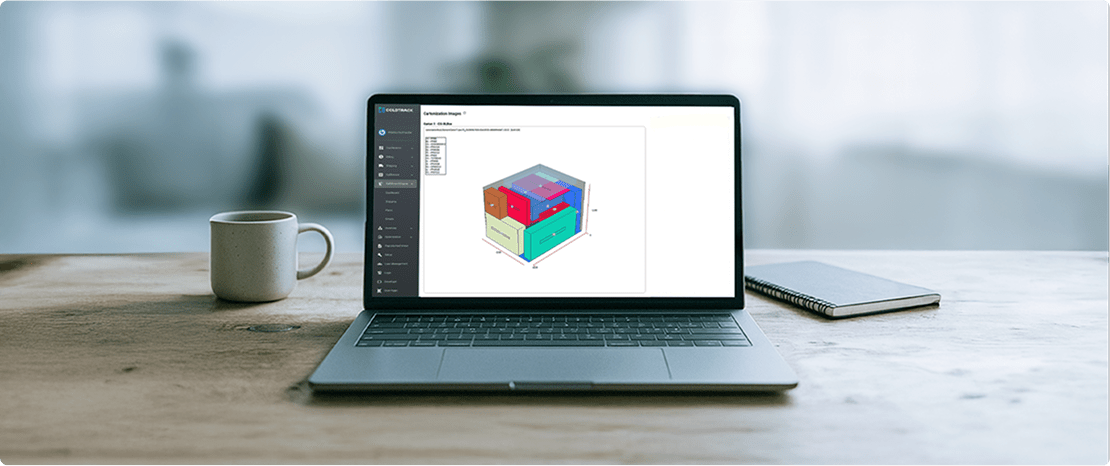 A laptop sits on a desk next to a coffee mug and notepad, the laptop screen shows the ColdTrack Live order configurator in action