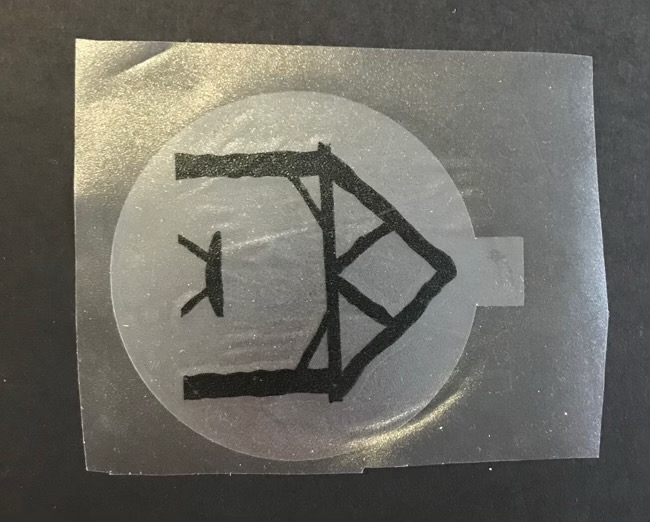 Photo of the acetate center with the vinyl image placed perfectly with a piece of medium tack transfer tape.