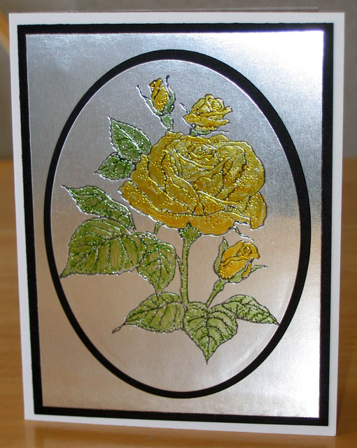 Photo of a heat embossed rose colored with yellow Copic Markers for today's Flashback Friday Copic Markers & Metallic Paper post.
