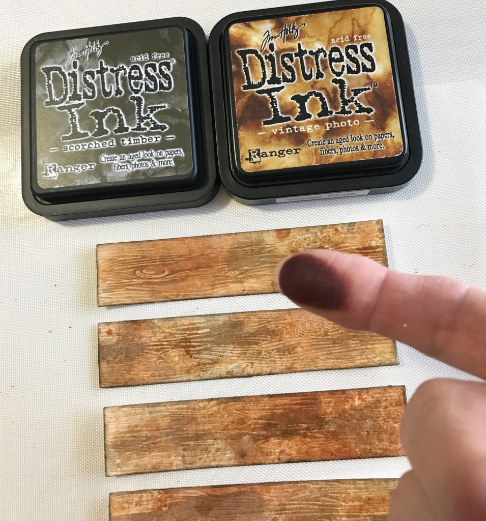 Photo showing my dirty finger after applying Distress Inks to add extra color and depth to the Honey Bee Stamps Barn Wood Planks die cuts for today's post.