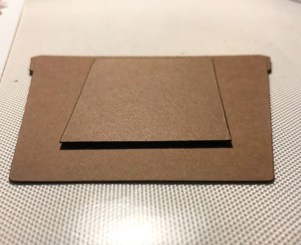 Photo showing the card scraps glued to the back of the flower pot. 