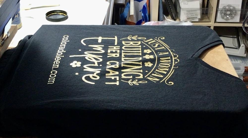 Photo of the finished screen printed-shirt. Also showing the small amount of puckering on the shirt caused by the shirt not staying adhered to the press platen.