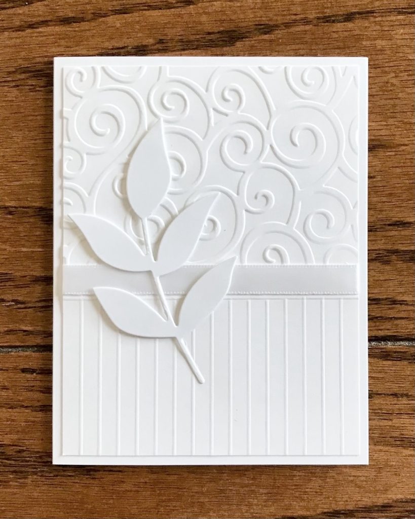 Photo of the most elaborate card made for today’s Elegant White on White Cards: Simple and Beautiful post, featuring the Devine Swirls Cuttlebug embossing folder, Offray Ribbon and scored lines from a score board.