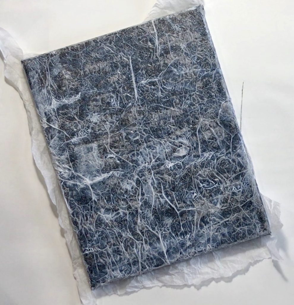 Photo showing all of the tissue paper adhered to the top and sided of the canvas for today's project.