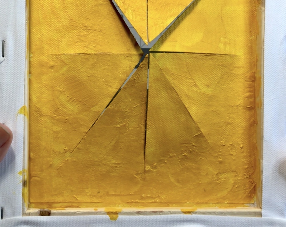 Photo showing the back of the cut canvas painted with Liquitex Basics acrylic paints in Gold and Cadmium Yellow Deep Hue.