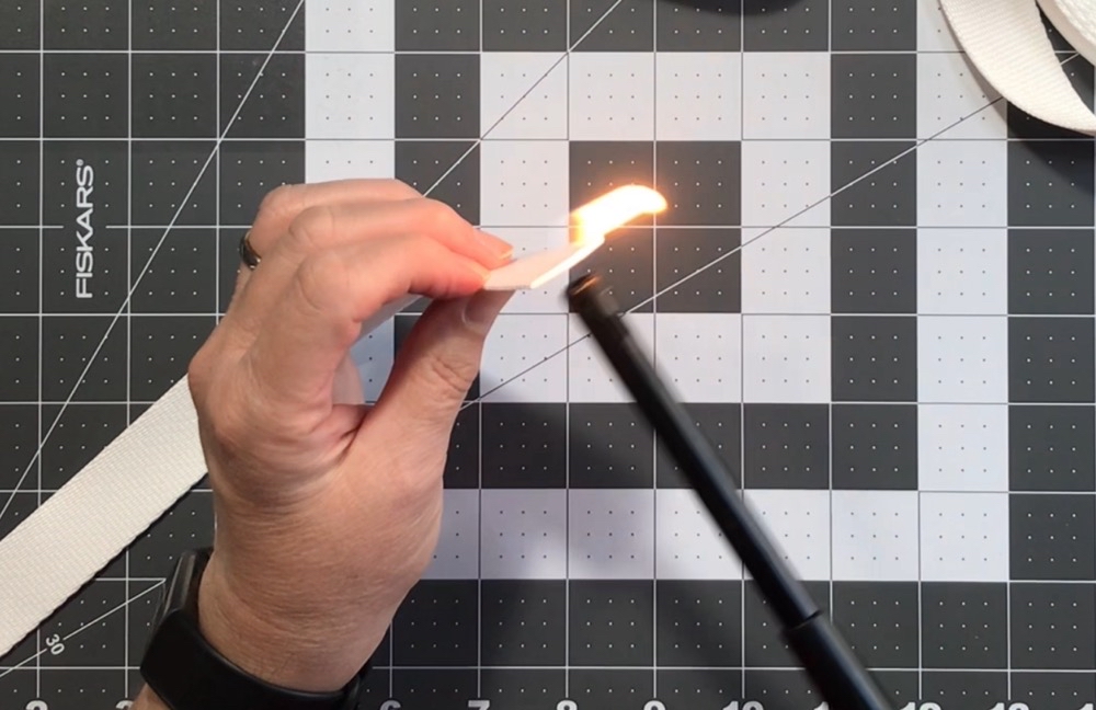 Photo showing how I tried to burn/melt the cut edge of the polyester webbing with the Scripto lighter.