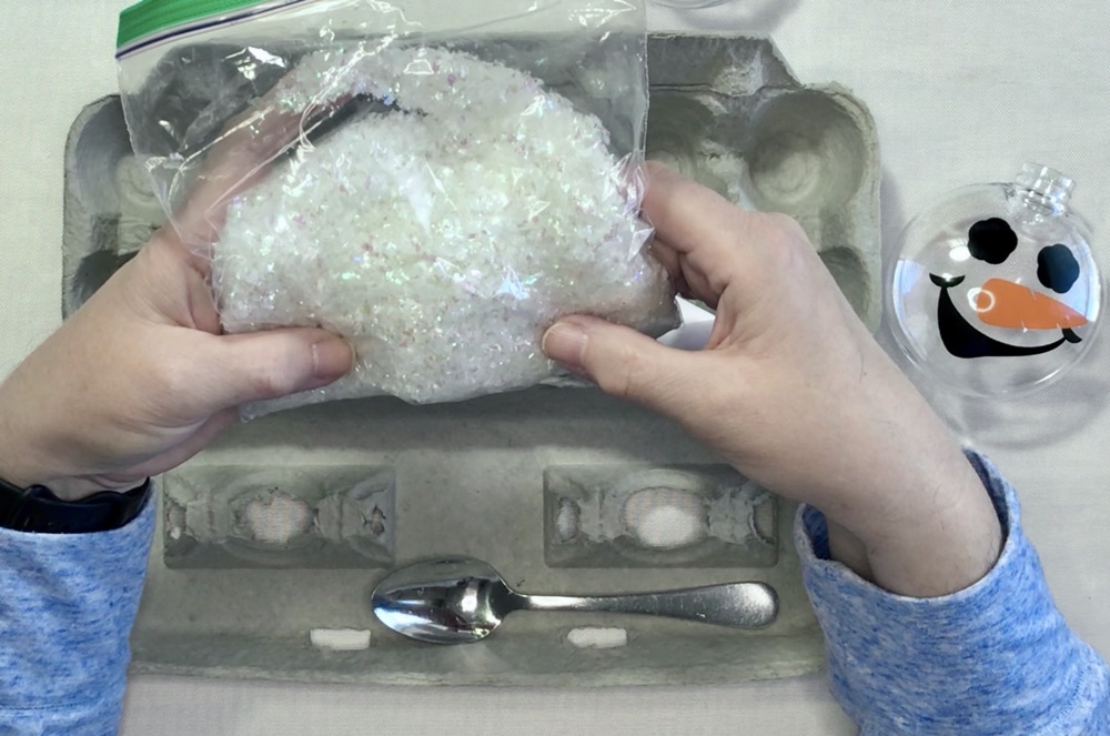 Photo showing the supplies used to add the fake snow into the snowman ornaments.