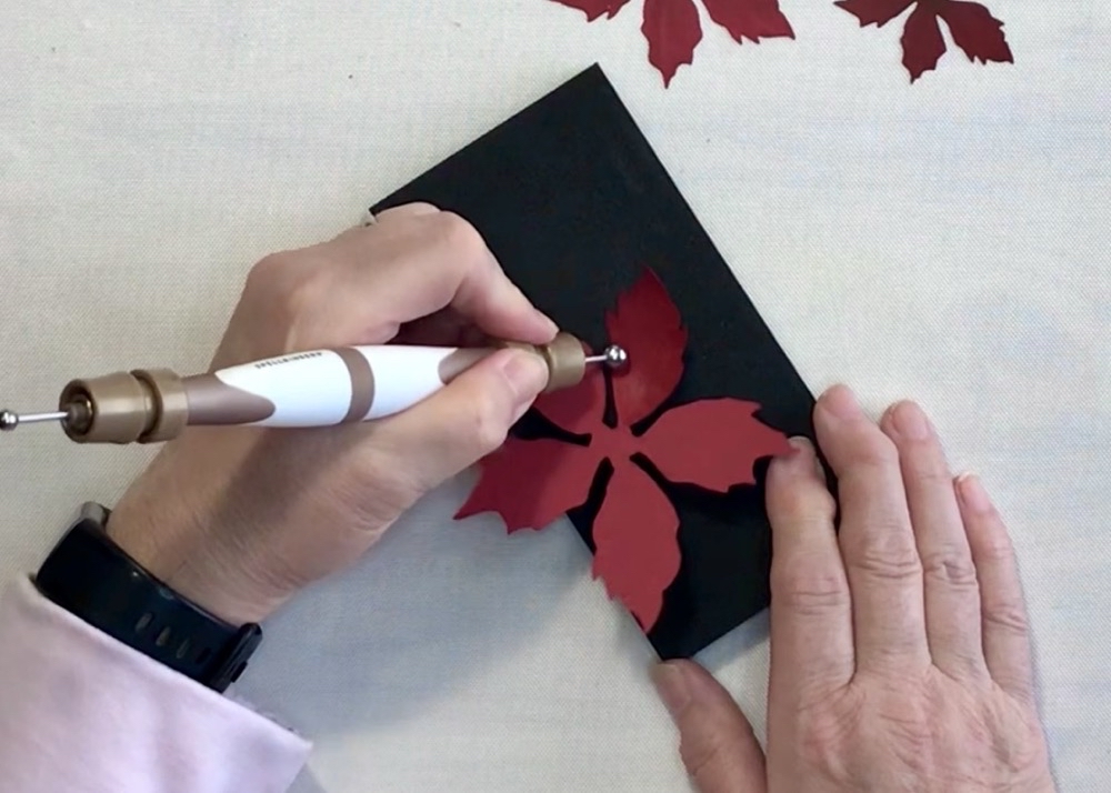 Photo of shaping the flower layers with the Susan's Garden Ultimate Tool Kit. This photo shows how I shaped the back of each petal with the large ball stylist.