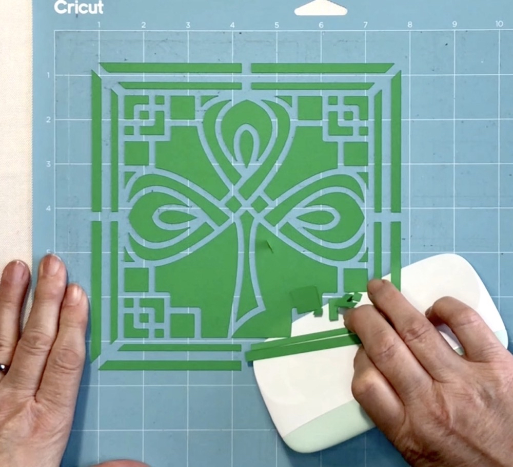 Photo showing how I remove the excess paper left after cutting the top layer of today's Easy 3D Celtic Shadow Box project.
