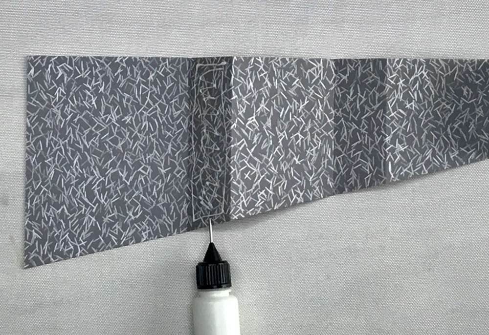 Photo showing where I add adhesive to glue my pleated curtain closed for today's How to Make a Curtain Fold Card post.
