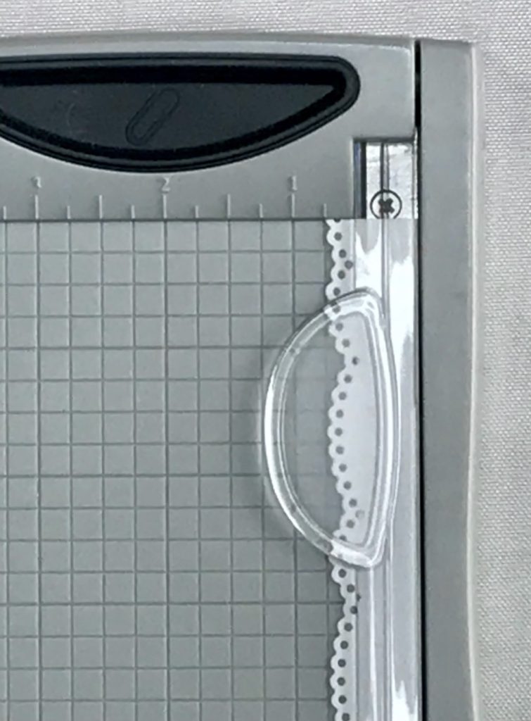 Photo showing cutting the valance to a width of 3/4" for the top of the How to Make a Curtain Fold Card project.