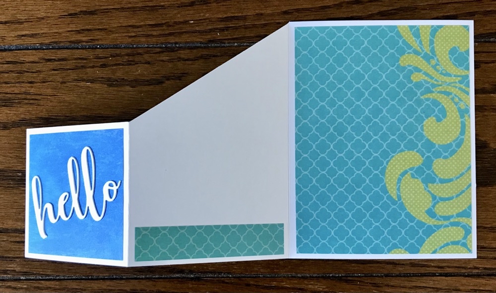 Photo of the inside of the second inspiration card showing an added piece of pattern paper at the bottom of the center panel.