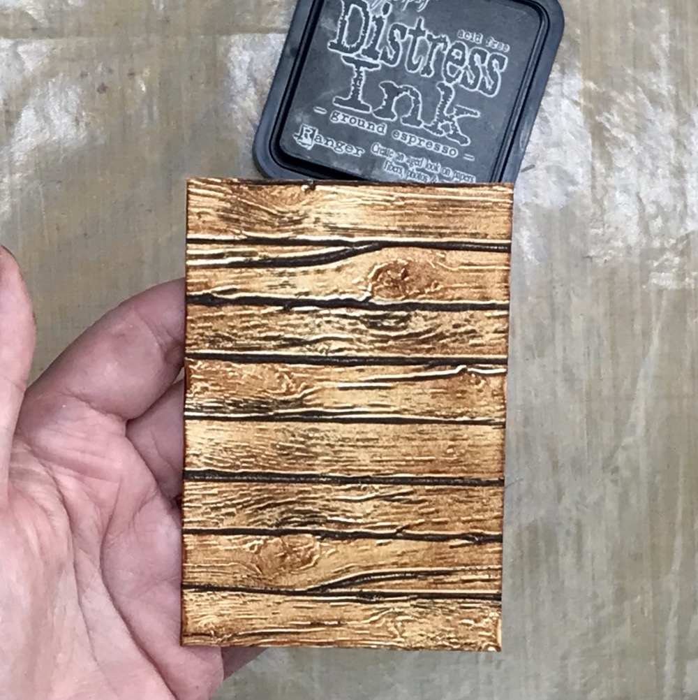 Photo showing how much darker the embossed lines are of the panel, a much better looking piece of "lumber".