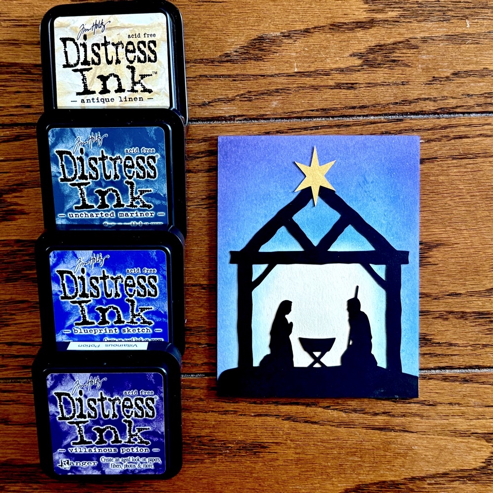 Photo of my finished Silent Night card and the Distress Inks used to create the background for the November 2025 SVG Card Crafters Success Summit.