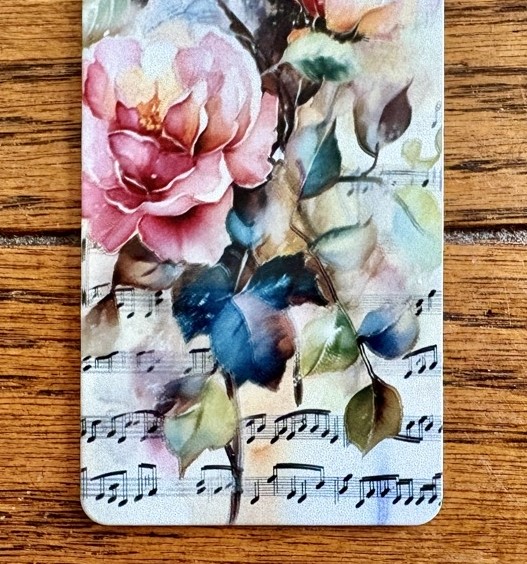 Close-up photo of the double sublimated bookmark showing how far off the print was lined p for today's How to Sublimate Metal Bookmarks post.