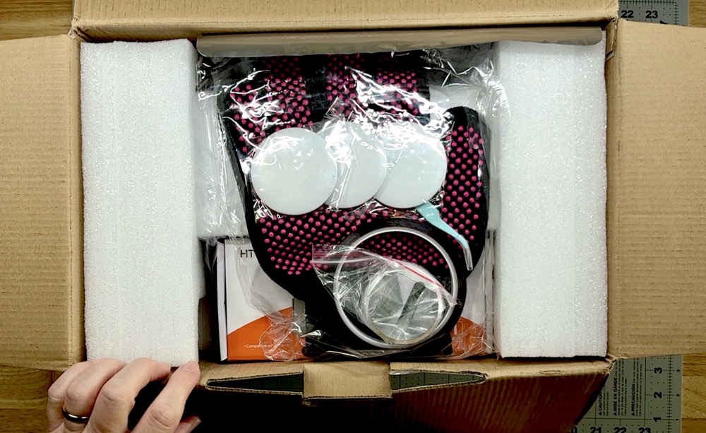 Photo of the contents of the box as soon as it was opened for today's Unboxing the HTVRont Phone Case Heat Press post.