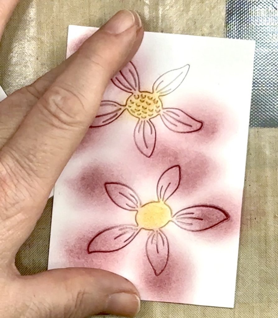 Screen shot showing the first wash of color with Distress Ink Aged Mahogany over the Etched Layered Daisy petals.