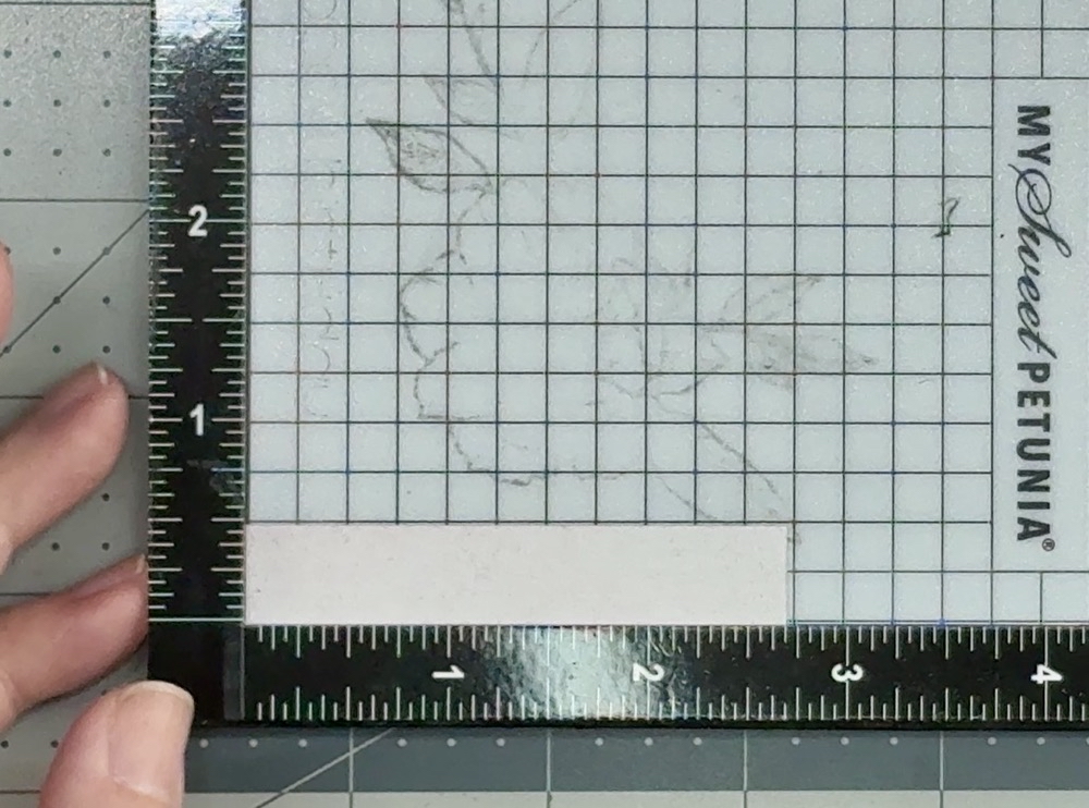 Photo showing how I line up the sentiment strip that has been inked with Lost Shadow distress ink in the Mini Misti