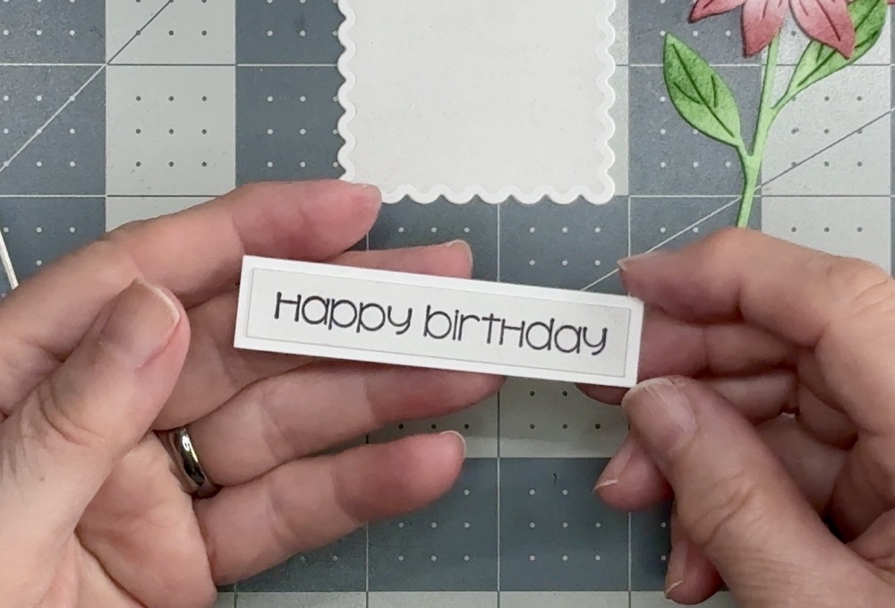 Screen shot showing the sentiment strip and mat ready to be placed onto the finished Easy Clean And Simple Layered Floral Birthday Card.