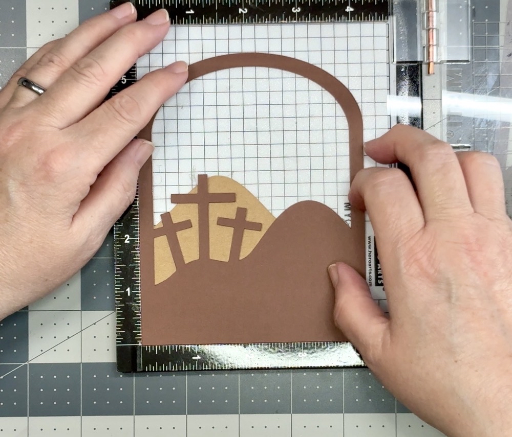 Photo showing the careful placement of the middle layer to the back layer with the help of the Mini Misti Stamping tool.