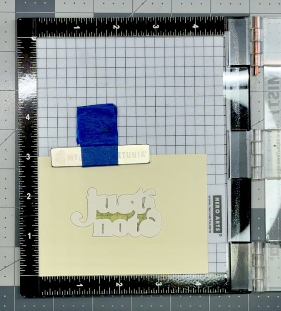 Photo showing the die cut in place in the template ready to stamp the sentiment for today's Six Floral Cards from One Simple Layout project.