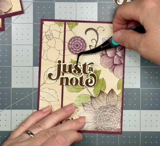 Photo showing the placement of the first sentiment onto the card front for today's Six Floral Cards from One Simple Layout post.