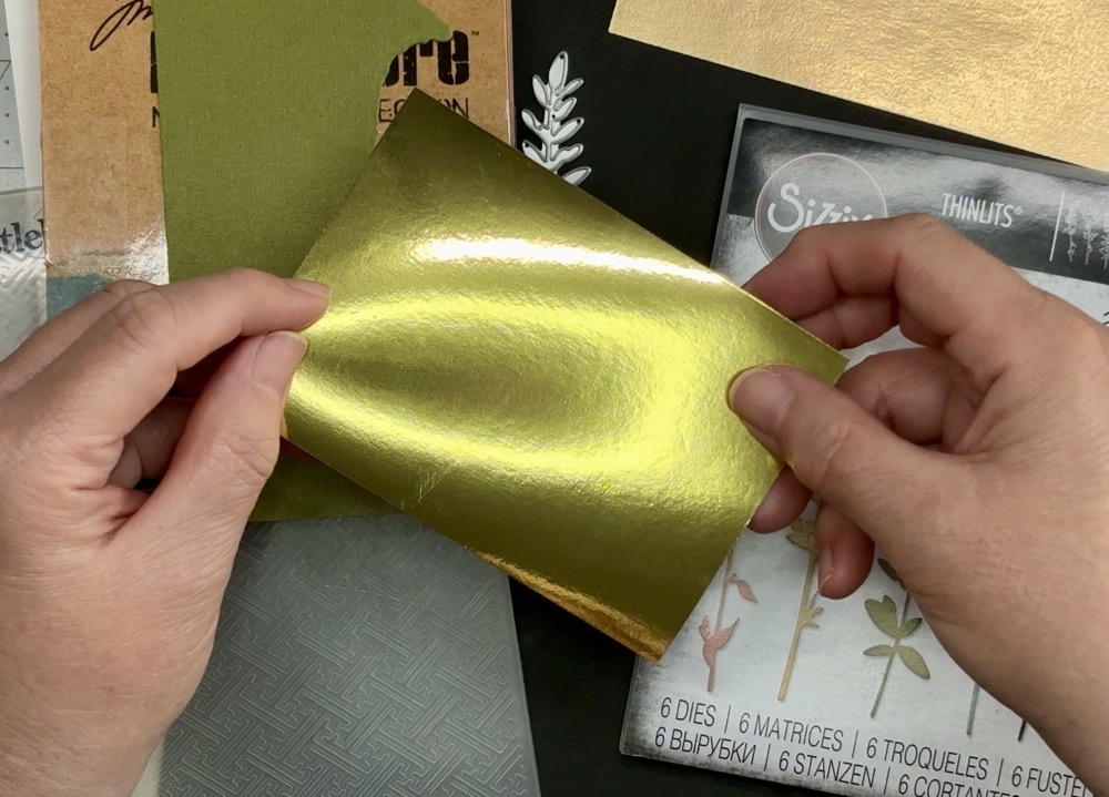 Photo of a scrap piece of gold mirror card from Michaels or Hobby Lobby used in todayโs project.