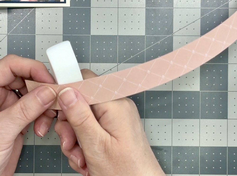 Screen shot showing how to loosen the fibers of the paper before creating a belly band for any project by using a bone folder and “curling” the paper gently.