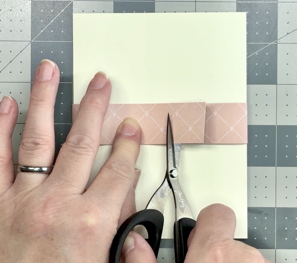Screen shot showing how I am trimming about an inch off of the belly band paper so it is hidden under the sentiment label.