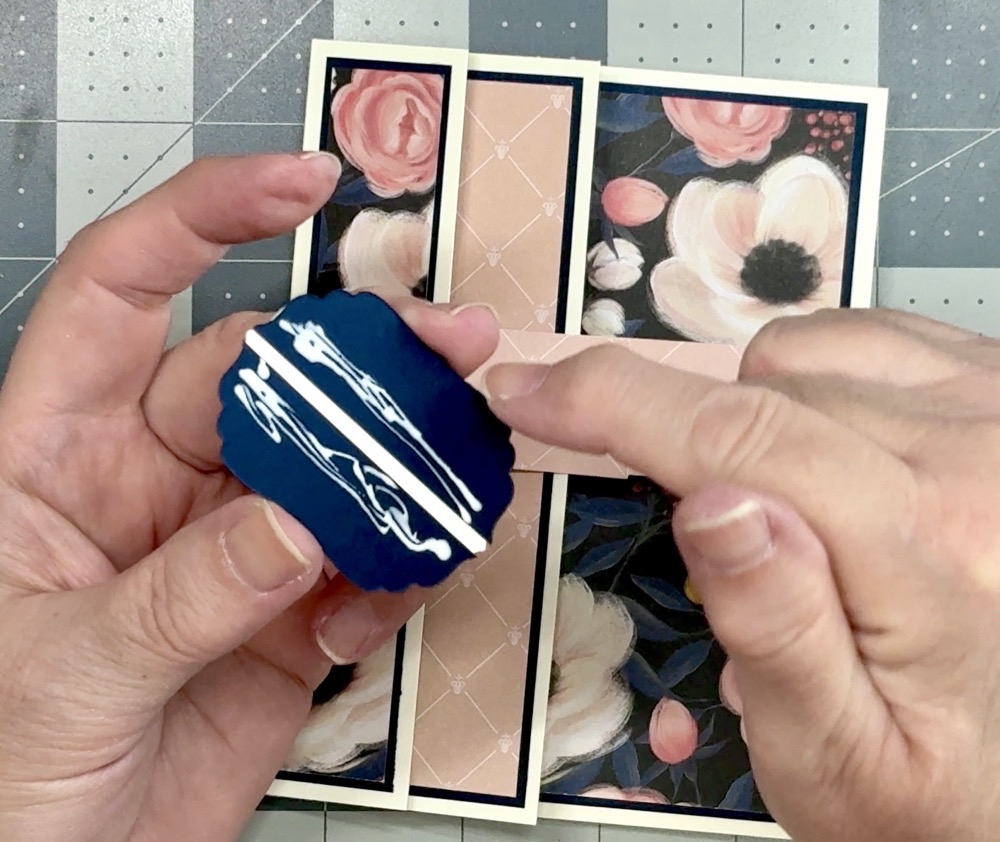 Screen shot showing the placement of the Bearly Art Glue on the back of the sentiment label before adhering it to the belly band.