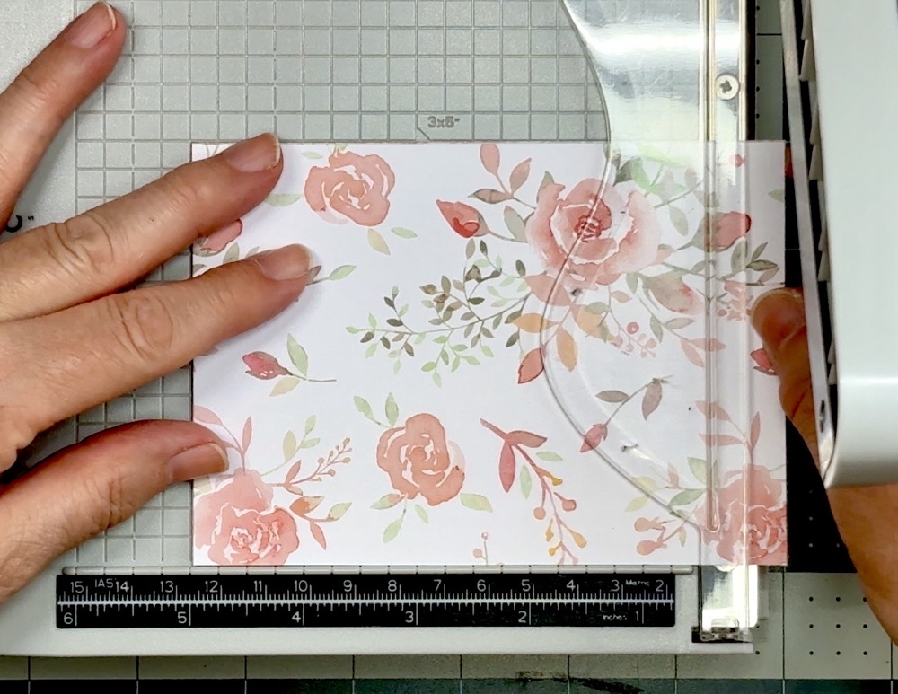 Screen shot showing the stack of pattern paper being cut to the finished size of 5” tell for today’s project.