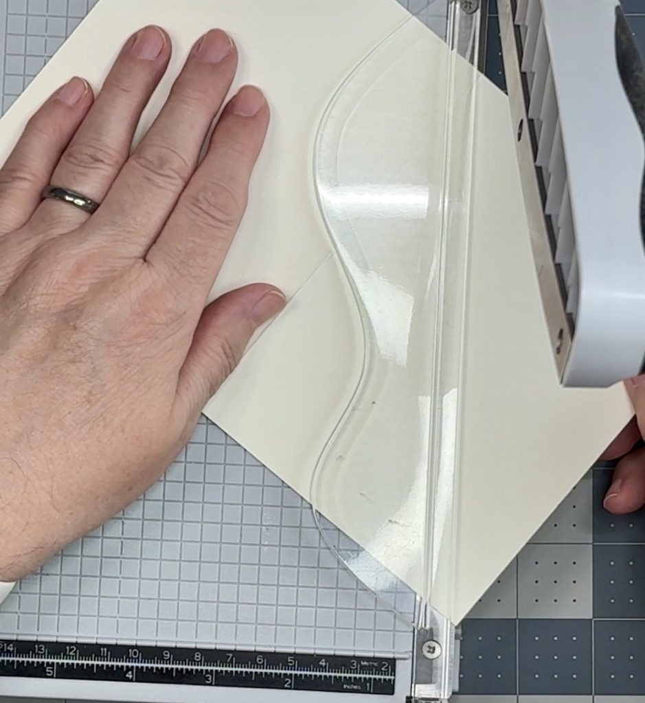 Screen shot showing how to line up the card front in the paper trimmer to make the diagonal cut from the score line to the lower right corner of the card. 
