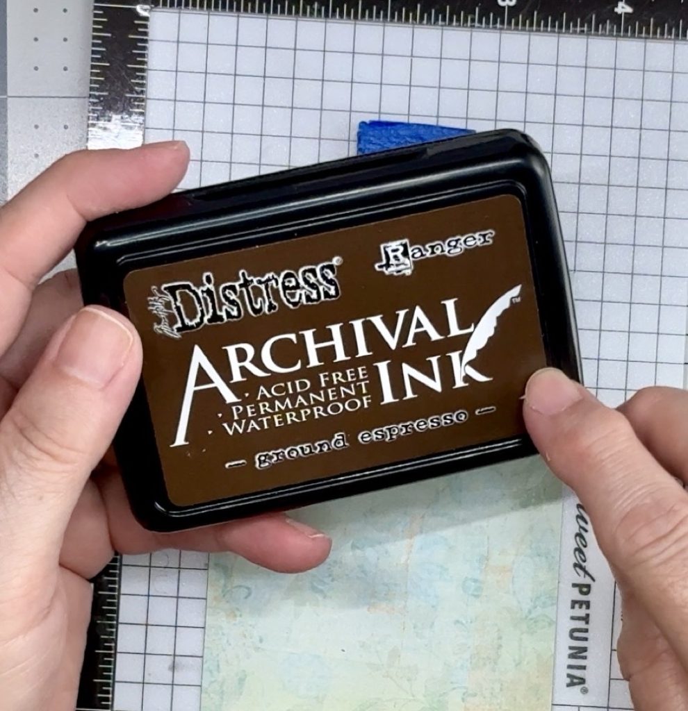Screen shot showing the Distress Archival Ink in ground espresso that is used to the stamp the sentiment onto the front pattern paper piece.