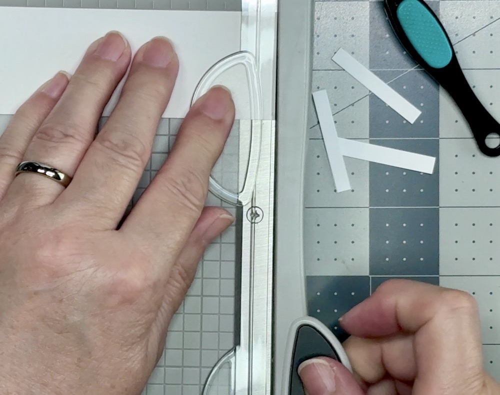 Screen shot showing how I cut scrap cardstock into ¼” strips to use to elevate the sentiment strip on the card front.