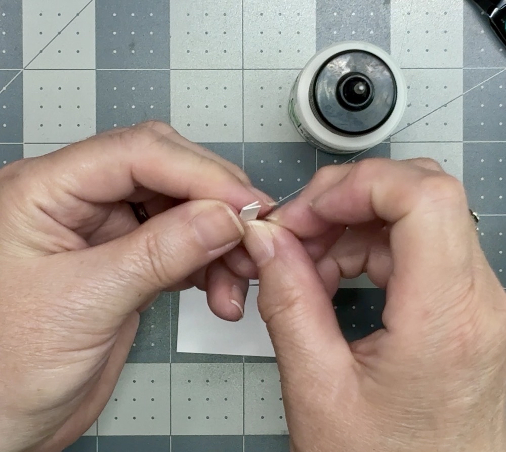 Screen shot showing gluing two cardstock strips together to create lift on the How to Make a Front Flip Fun Fold Card project.