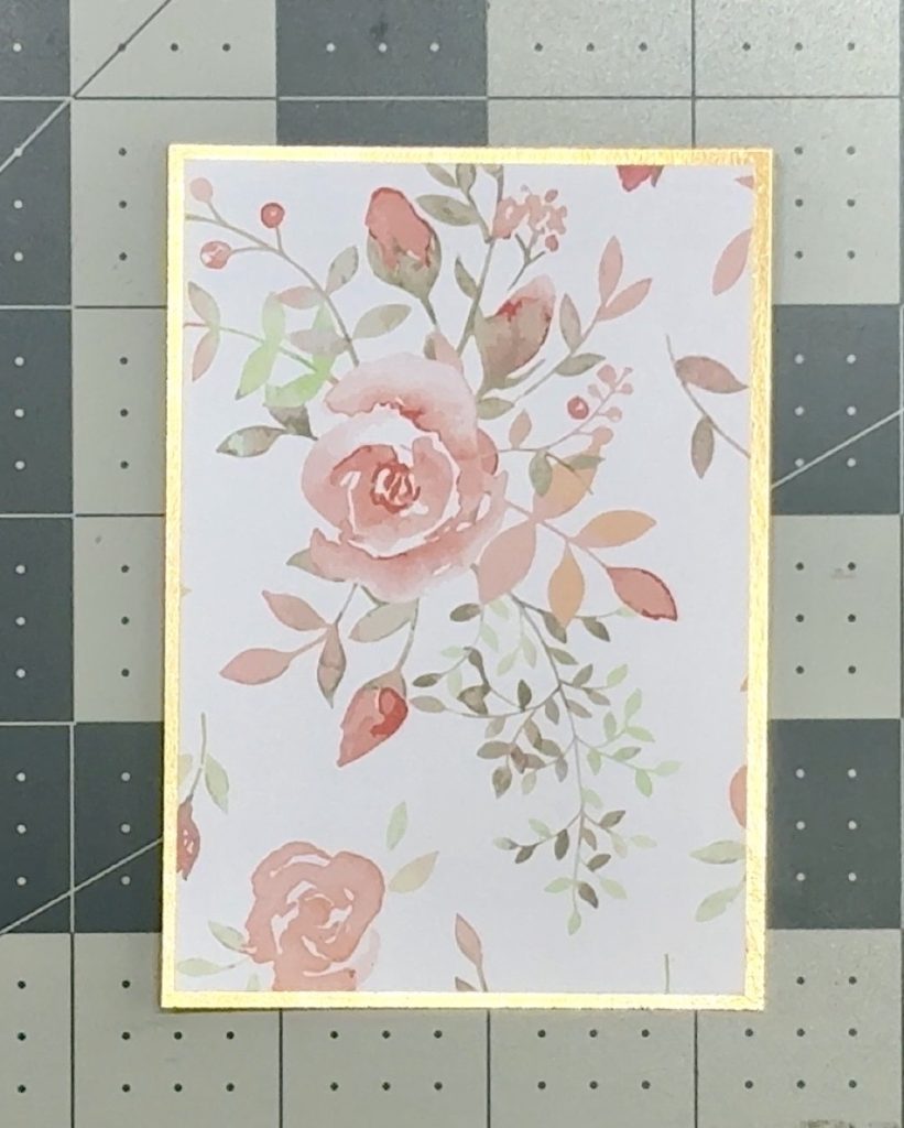 Screen shot showing a foil cardstock mat cut to 2 7/8” x 4 1/8” and a scrap of pattern paper from the Sage Park Recollections paper pad cut to 2 ¾” x 4” for the front flap.