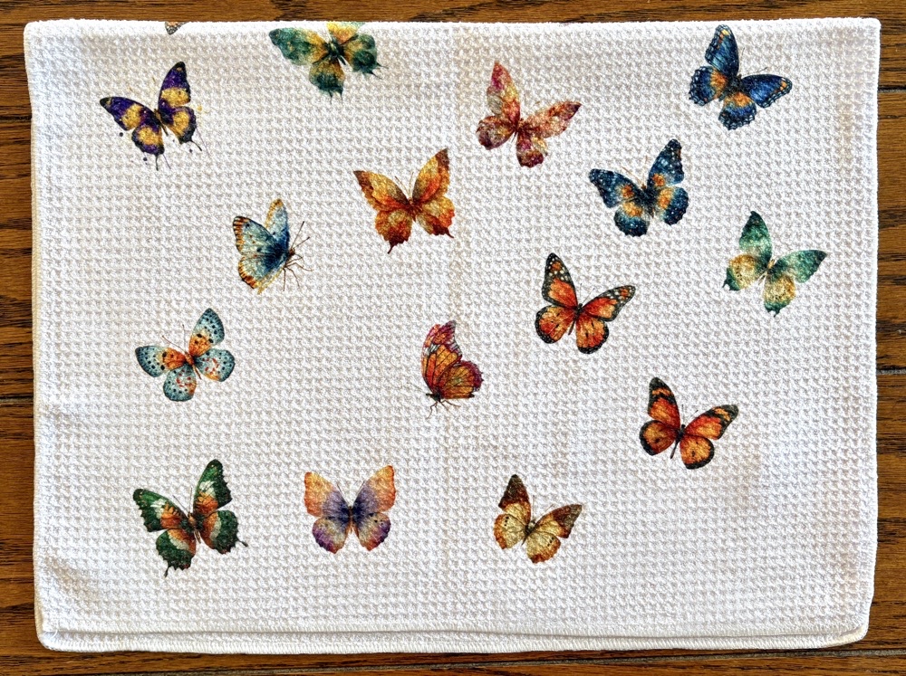 Photo of the back side of the Bonus All-over Butterfly kitchen towel with images from the Watercolor Autumn Butterfly Clipart set from Creative Fabrica.