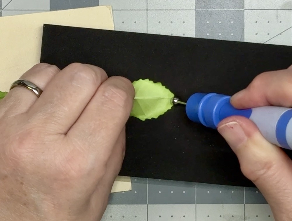 Screen shot showing the final step in shaping the leaf by holding the pinch and using the medium ball stylist to add shape to the back of the leaf for today’s Handmade Christmas Ornament with a Cardstock Flower post.