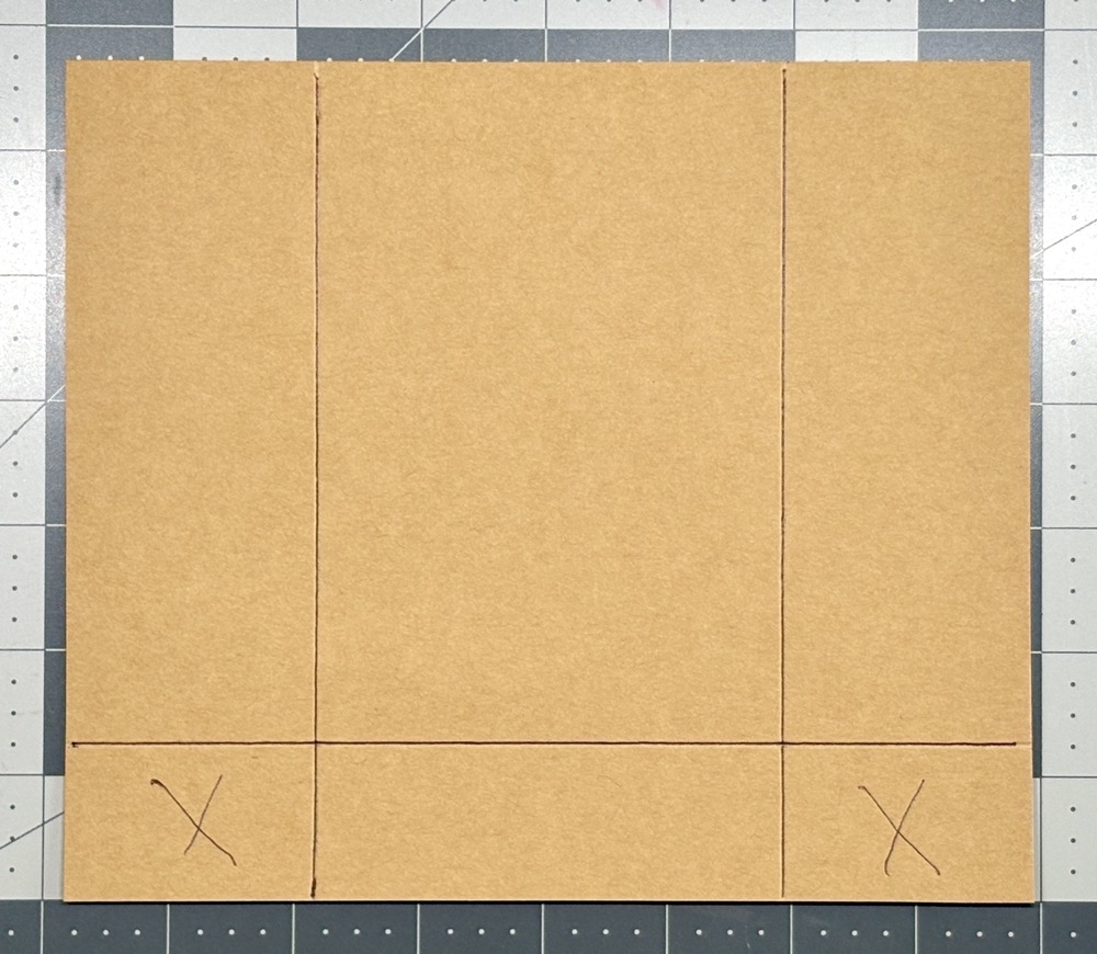 Photo showing the 7 ¾” x 6 ¾” piece of kraft cardstock scored with the 2” and 5” lines as well as an additional score line at 1 ¼” from the bottom to create the packaged gift card holder without the gift bag punch board.