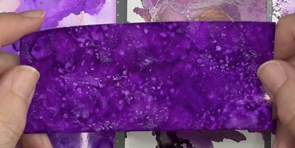 Screen shot showing a scrap piece of white Oracal 651 permanent vinyl with the alcohol ink color pallet of Eggplant, Wild Plum and  hint of Boysenberry.