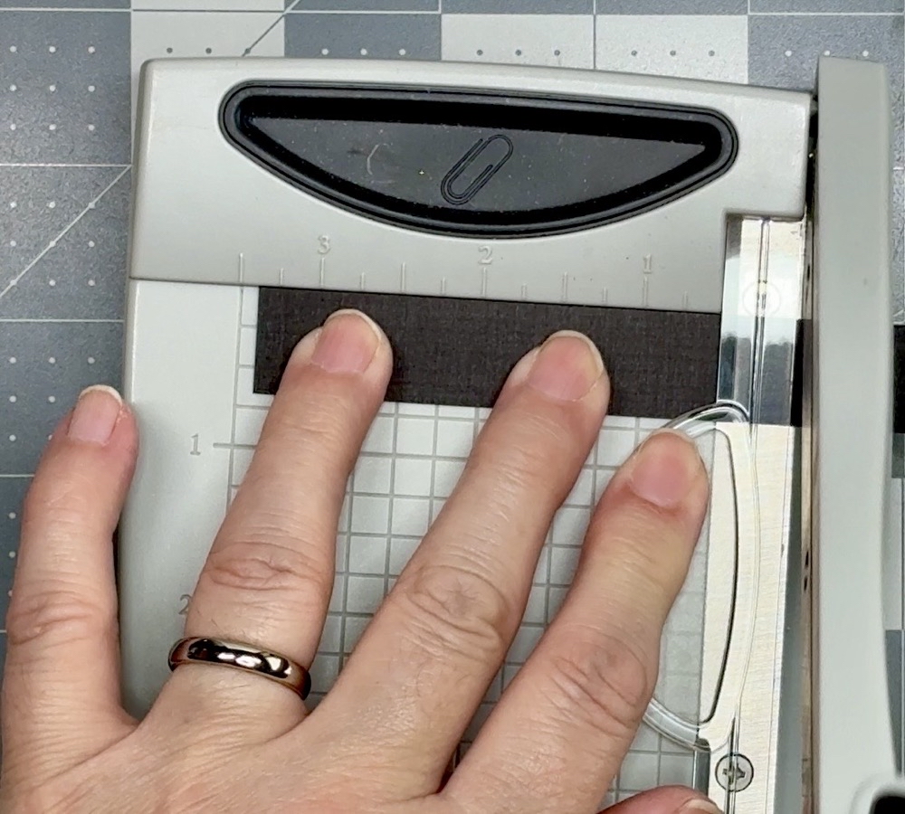Screen shot showing trimming a 5/8” tall black linen-textured mat for the card’s sentiment.