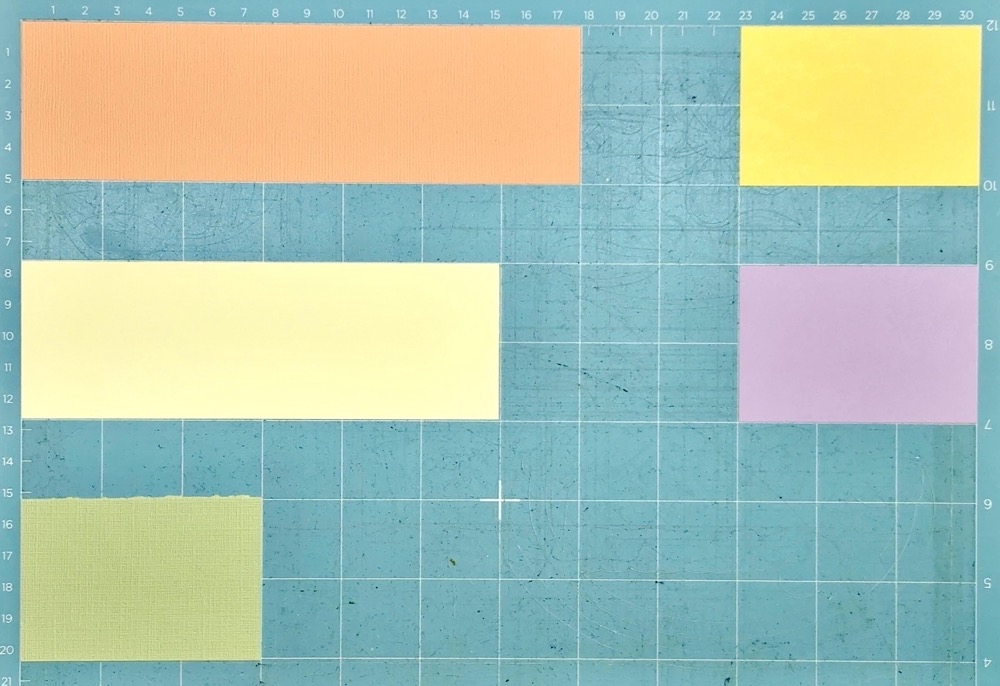 Photo of my Cricut Light Grip cutting mat with the different colored card aligned to match the mat on the screen ready to cut. 