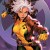 Variant comic book cover for Uncanny X-Men #34 featuring Rogue in her classic yellow-and-green X-Men uniform and brown jacket, with her distinctive white-streaked brown hair. She stands in a dynamic fighting pose with clenched fists against a purple background featuring the X-Men logo.