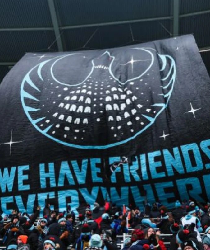 A large banner reads 'We have friends everywhere' with a symbol of a bird used in Star Wars to signal the resistance. 