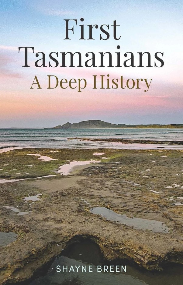 The cover of the book First Tasmanians which features a photo of a coastal landscape.